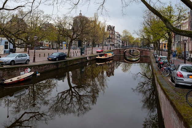 Amsterdam canals and typical houses with a morning spring sky..