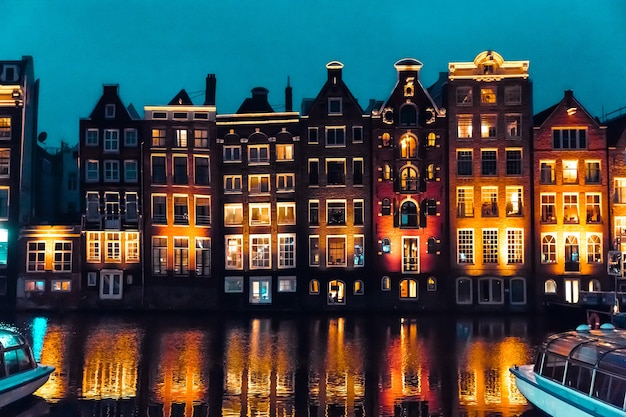 Amsterdam, Netherlands, Europe Traditional old narrow houses and canals in Amsterdam, the capital of the Netherlands in autumn night. High quality photo