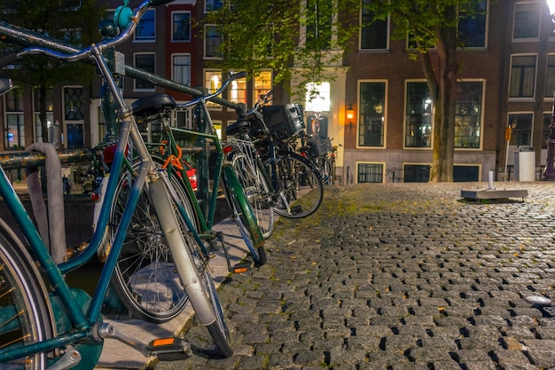 Amsterdam at night and parked bicycles