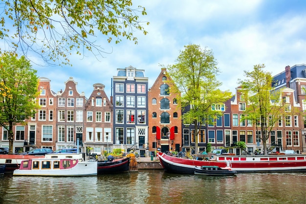 Amsterdam View of the old houses canal and boats Famous place in the old center of Amsterdam Amsterdam Holland Netherlands Europe