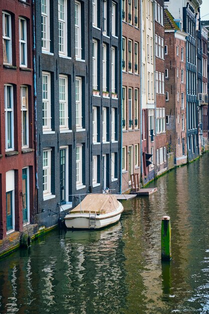 Amsterdamse gracht Damrak met huizen, Nederland