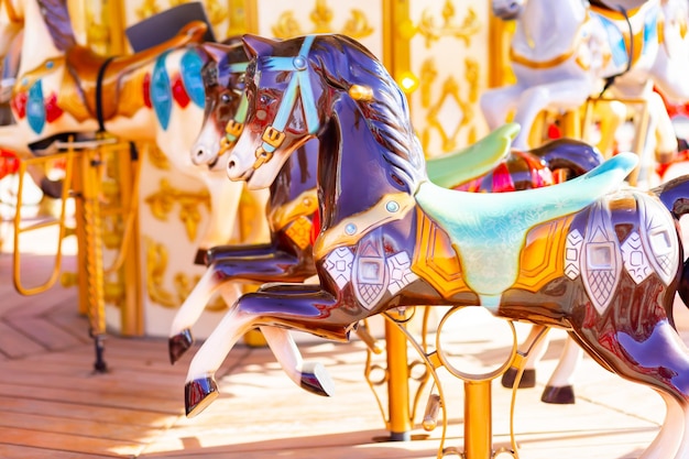 Amusement park carousel with beautifully painted wooden horses