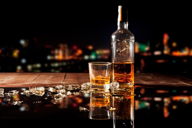 사진 알코올이 죽인다 빈 알코올 병이 테이블 위에 어두운 배경에
