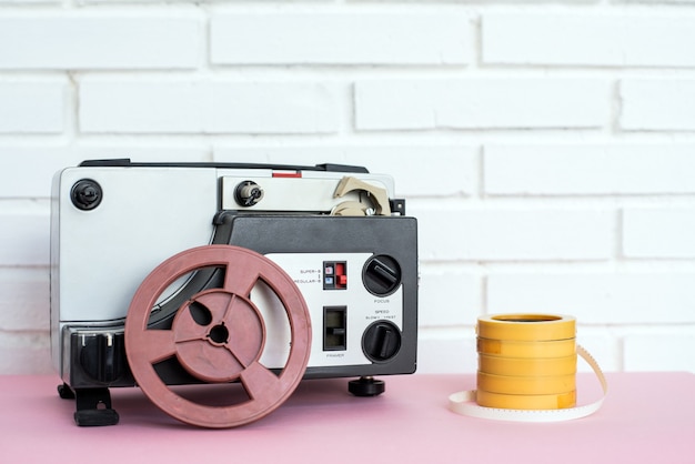 Analog audio device and tapes placed on table near white brick\
wall at home