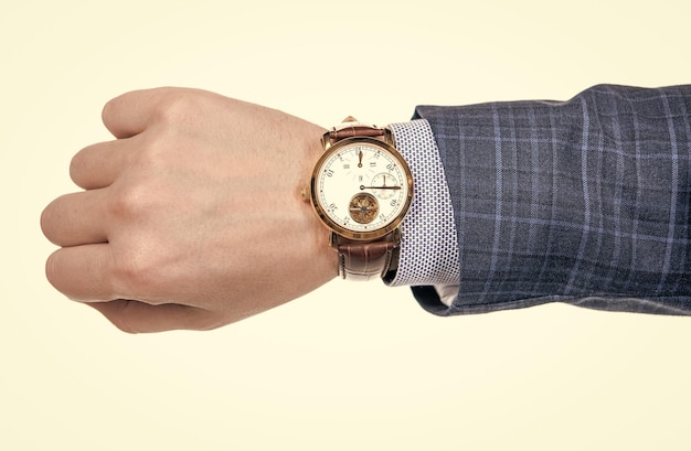 Analog wrist watch worn on male hand in business suit isolated on white deadline