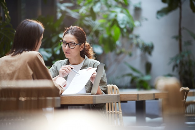 Analyst showing report to colleague