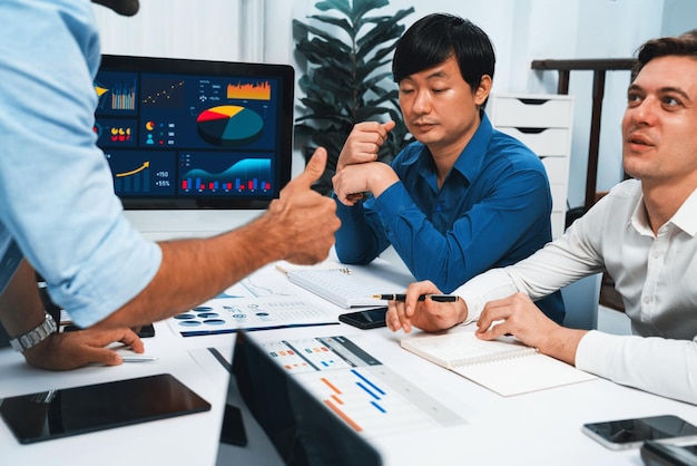 Analyst team utilizing BI Fintech to analyze financial data at table in meeting room Businesspeople analyzing BI dashboard power for business insight and strategic marketing planning Prudent