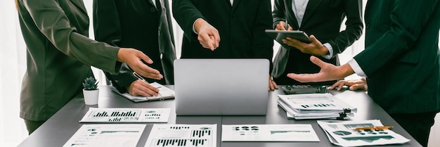 Analyst team working on BI Fintech to analyze financial dashboard paper at office workplace Businesspeople reviewing report paper on table for business insight Panorama shot Prodigy