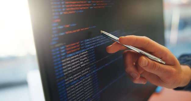 analyze code or hand in office with computer screen software error or data check in debug process programming man or system analyst in agency with pen performance or log review for best practice