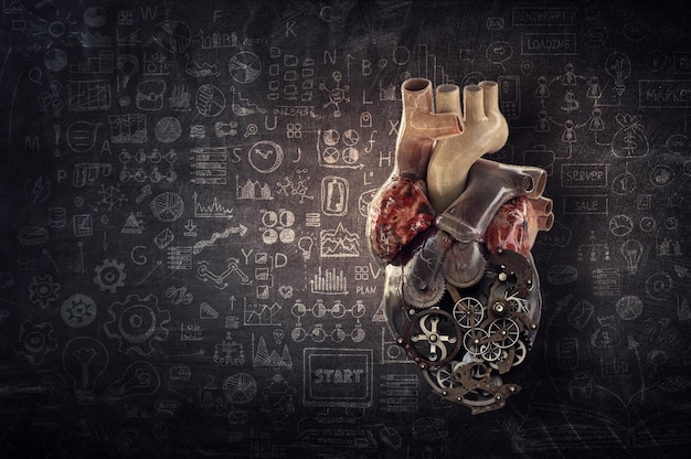 Anatomic heart model made with gears and mechanic parts,\
chakboard sketch background