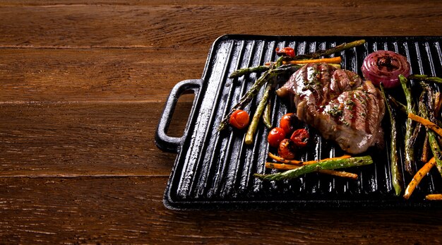 Ancho steak with grilled vegetables on the grill