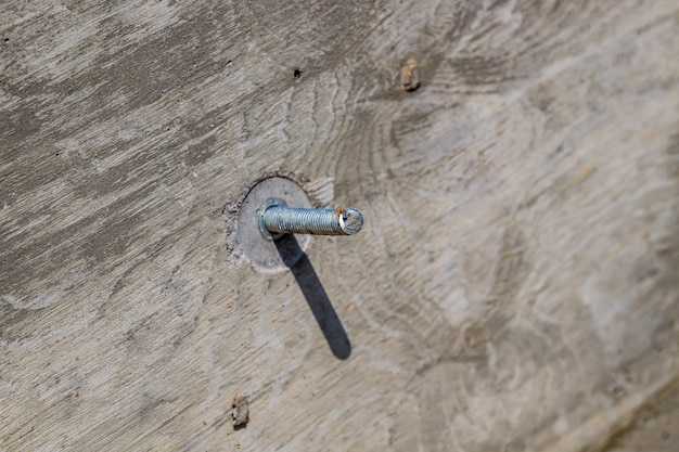 Anchor bolt in concrete wall closeup