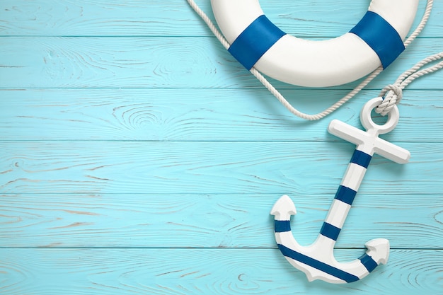 Anchor and lifebuoy on a vintage blue