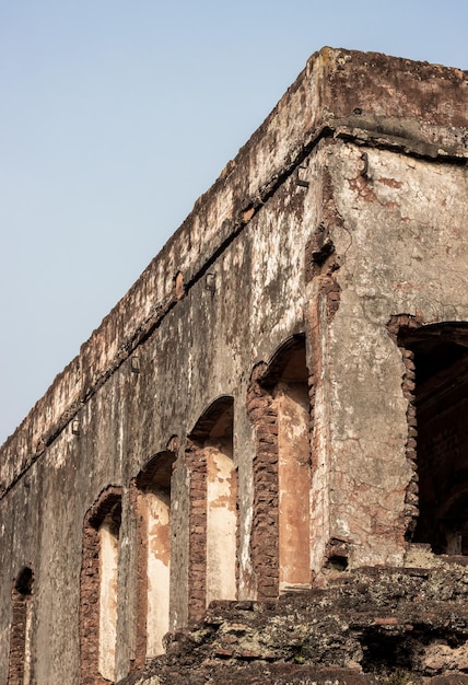 Ancient abandoned brick structural building under the cloudy sky