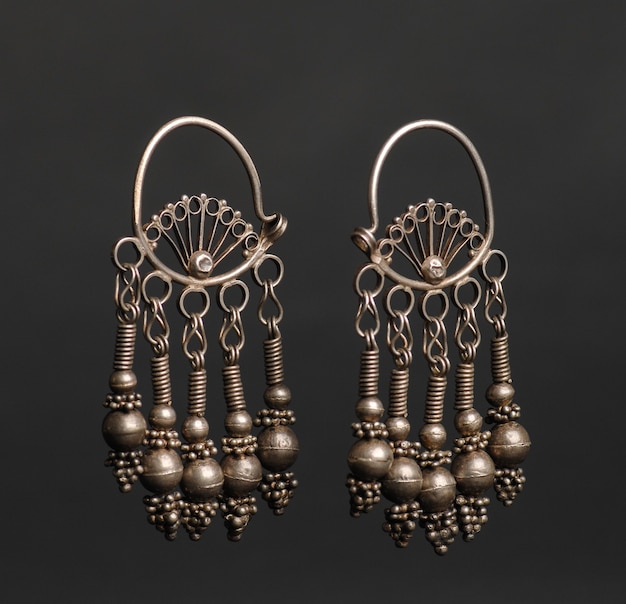 Ancient antique earrings on black background. Middle-Asian vintage jewelry