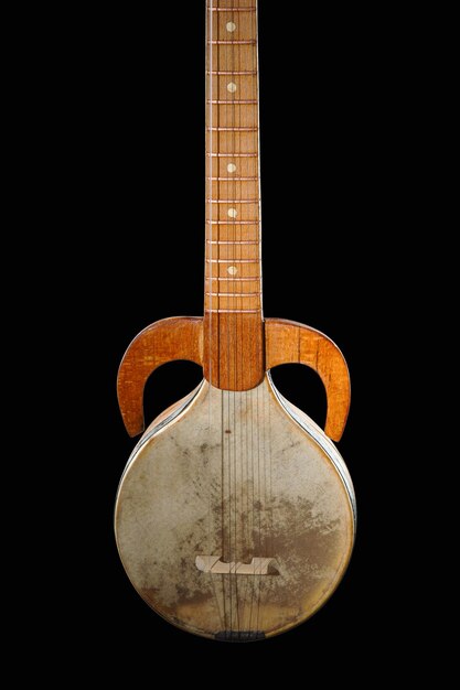 An ancient Asian stringed musical instrument on a black background