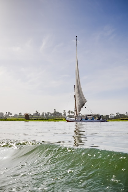 Ancient boat sailing on river