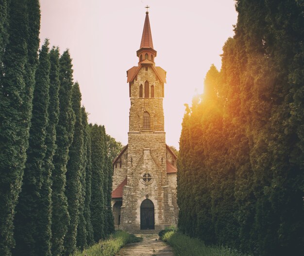 The ancient building of church made from stone at sunset