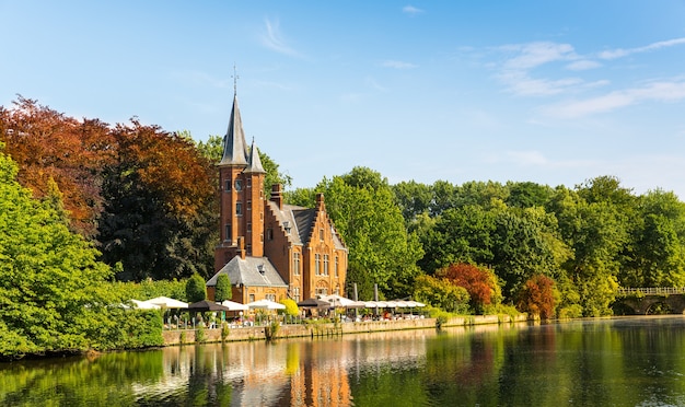 Ancient building with tower in green park, old European town.