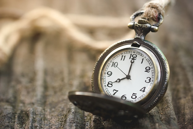 Ancient Clock Time 8.00 am Placed on old wooden