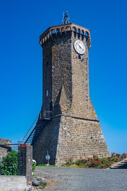 Foto l'antica torre dell'orologio, simbolo dell'antico borgo di marta, sulla riva del lago di bolsena in italia