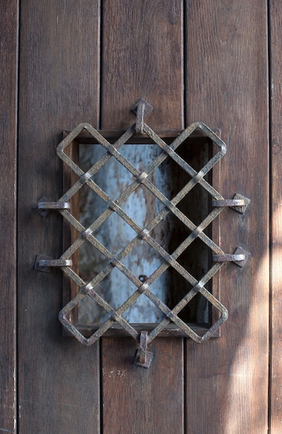 Ancient door with grate