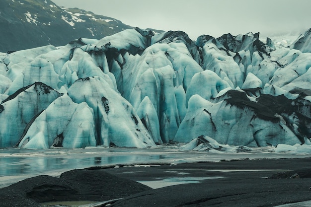 Ancient glacier on beach landscape photo