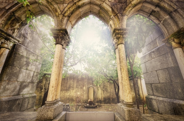 Photo ancient gothic arches in the myst. fantasy landscape in evora, portugal.