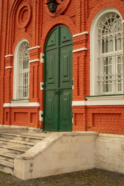 Ancient green door in the old town with a wooden gate