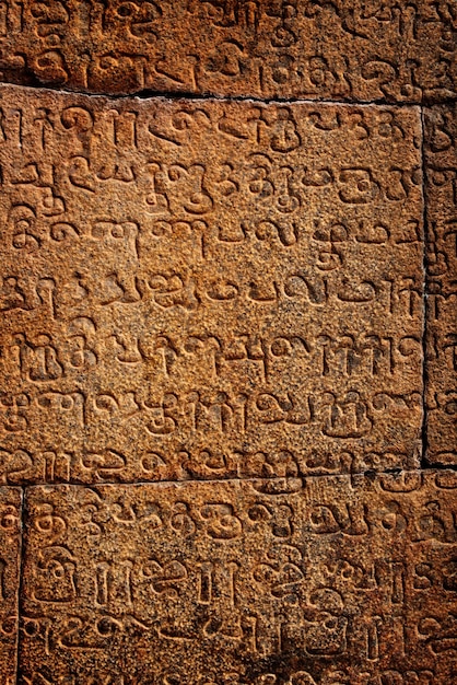 Ancient inscriptions on stone wall in Tamil language