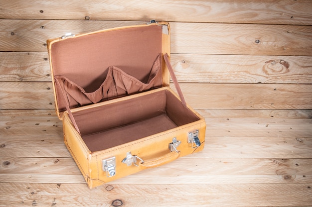 Ancient luggage on wood floor background is wood