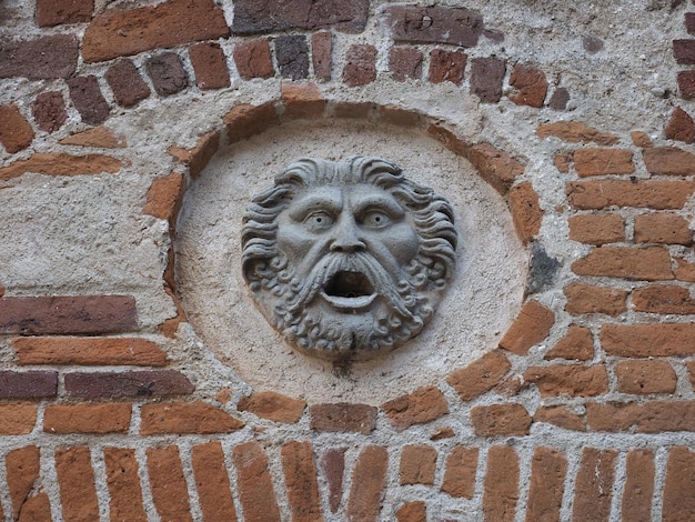 Ancient mask at Ricetto medieval village in Candelo