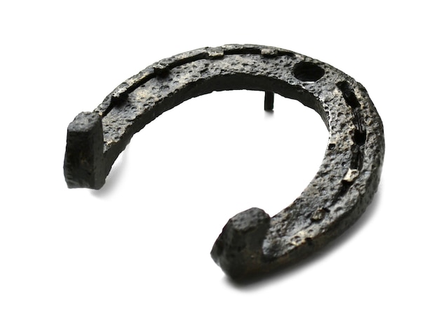 Ancient metal horseshoe on a white background