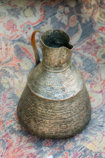 Ancient metal jug in oriental style