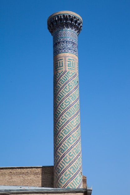 Ancient minaret with mosaics in the Gur Emir mausoleum in Samarkand in Uzbekistan.