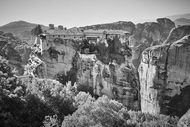 Ancient monastery on the cliff in Meteora in Greece - Black and white greek landscape