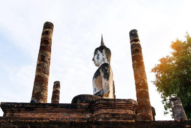 Ancient old Buddha statues and stone pillars