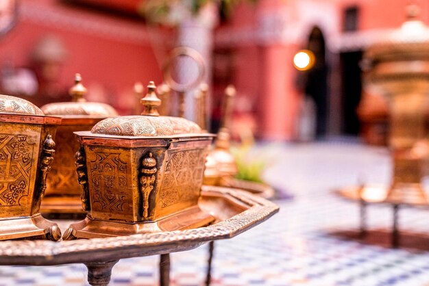 Ancient ornate brass pot with engraving on table