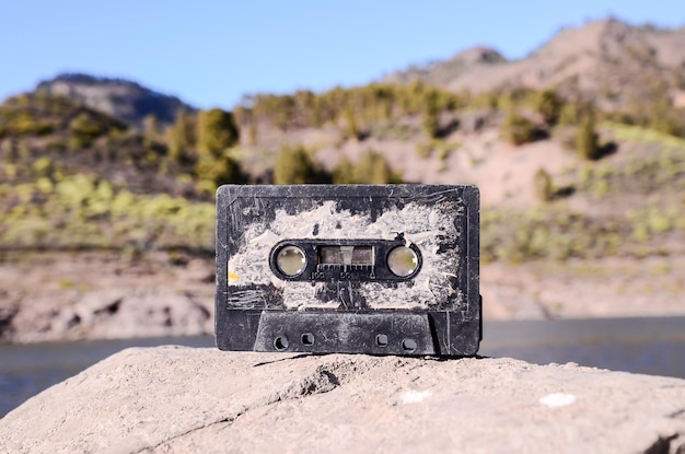 Ancient Retro Musicassette on the Rock into the Wild