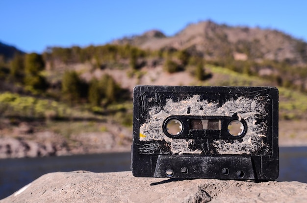 Ancient Retro Musicassette on the Rock into the Wild