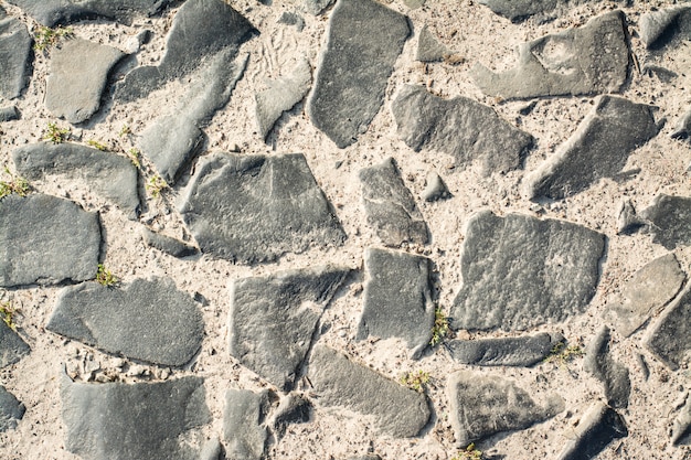 Ancient road made of cobblestone background texture