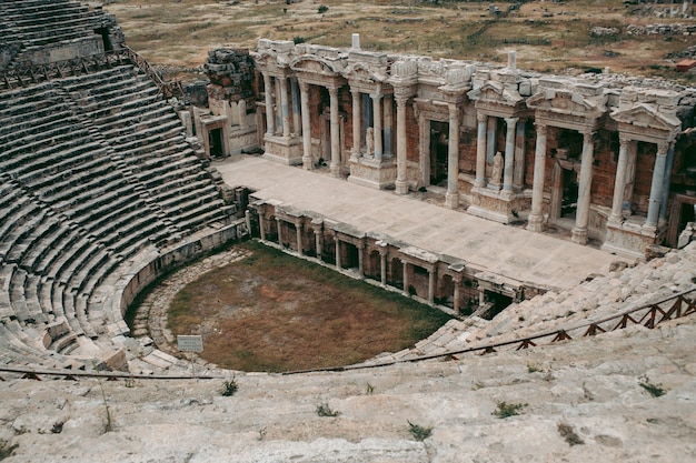 Ancient Roman amphitheater made of stone under the open sky in Pamukkale in Turkey