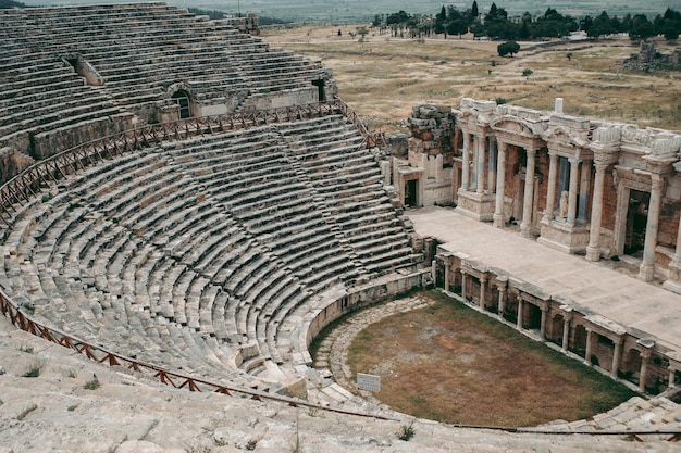 Ancient Roman amphitheater made of stone under the open sky in Pamukkale in Turkey