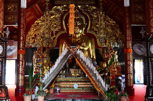 Ancient ruin buddha in antique old ubosot of Wat Ming Mueang temple for thai people traveler travel visit and respect praying blessing wish myth holy mystical at Chiangrai city in Chiang Rai Thailand