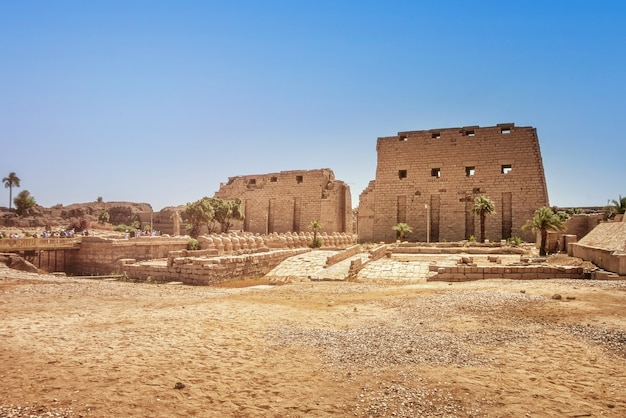 Ancient ruins of the Karnak Temple in Luxor (Thebes), Egypt. The largest temple complex of antiquity in the world. UNESCO World Heritage. View from sphinxes alley.