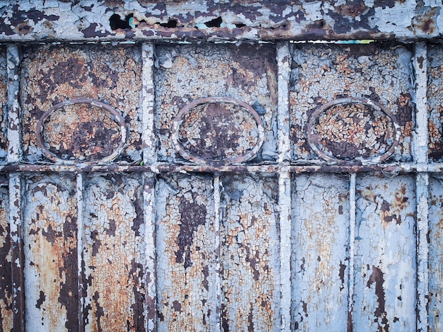 Ancient rust door, scratched blue paint and rust.