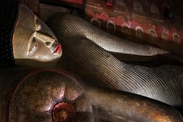 Ancient statue of a recumbent Buddha in the cave temple of Dambulla Sri Lanka