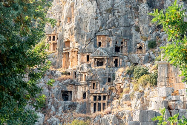 Ancient stone-cut tombs on the mountainside above the antique city of Mira in Demre, Turkey