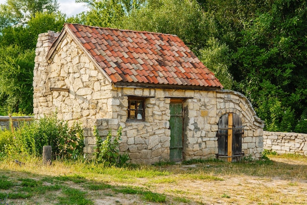 Ancient stone house with a roof of tile