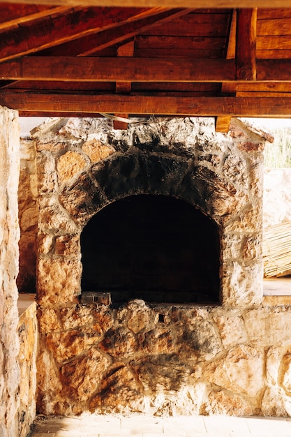 An ancient stone stove outside for cooking with black tan